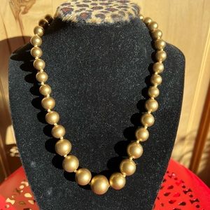 Gold faux pearls.